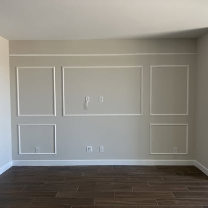 Decorative picture-frame molding installed on an interior feature wall