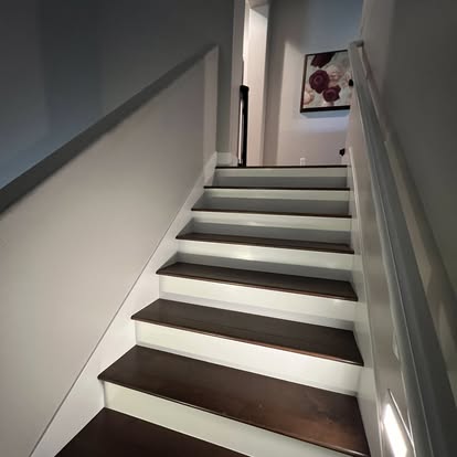 Completed staircase with dark wood treads and white risers